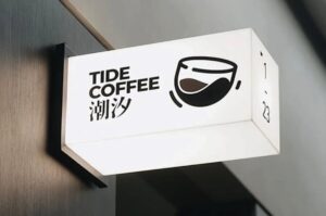 Tampilan Neon Box Vinyl Jakarta yang menyala terang dengan desain grafis tajam di depan toko saat malam.